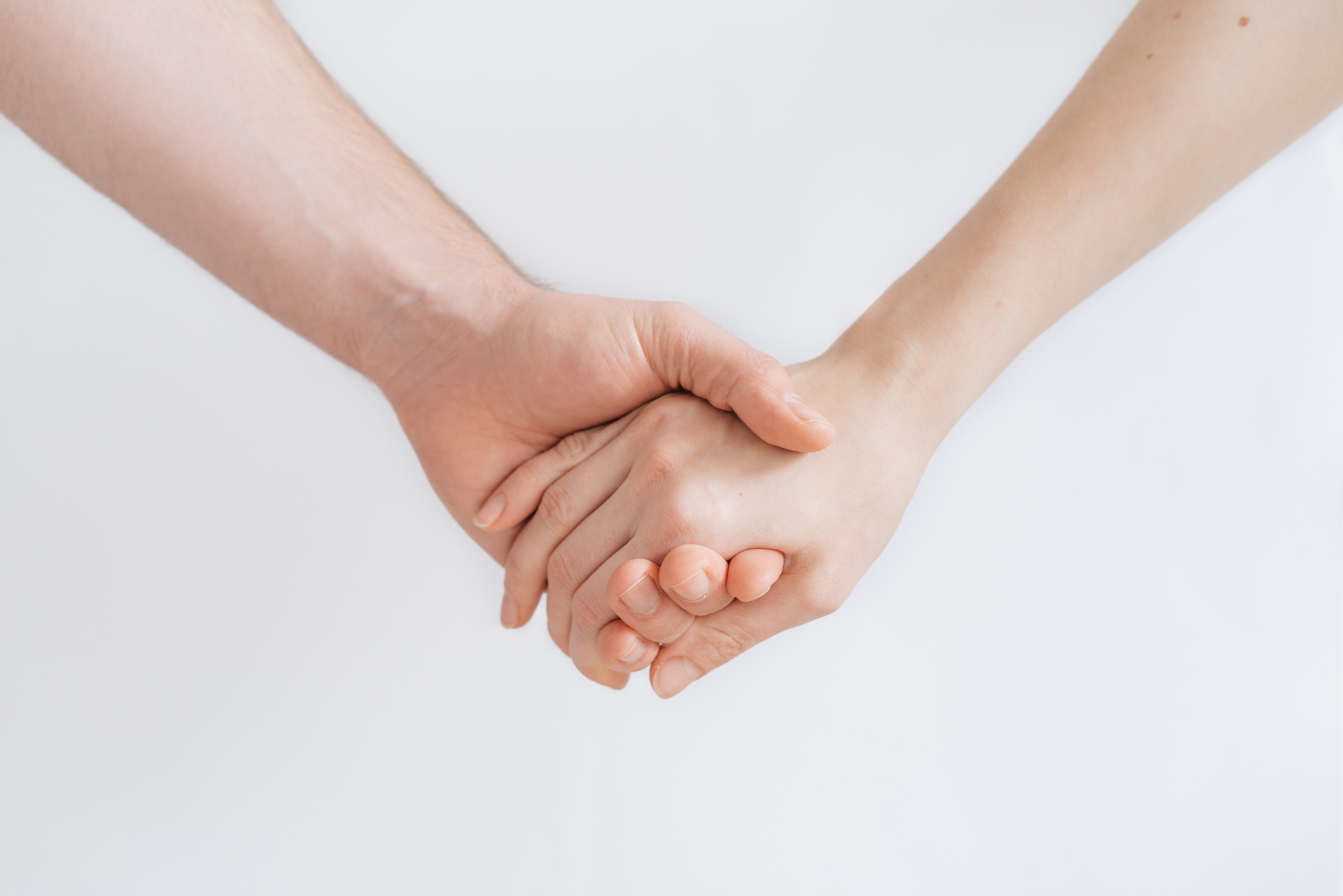 a picture of two hands holding each other.